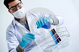 Biochemistry laboratory research, Chemist is analyzing sample in laboratory with equipment and science experiments glassware