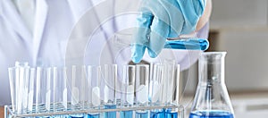 Biochemistry laboratory research, Chemist is analyzing sample in laboratory with equipment and science experiments glassware