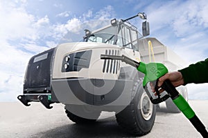 Biofuel filling station on a background of mining truck. Decarbonization of heavy industrial vehicles. photo
