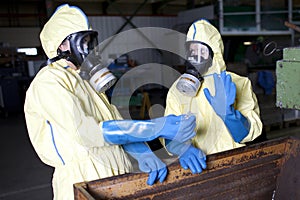 Biohazard experts disposing infested material