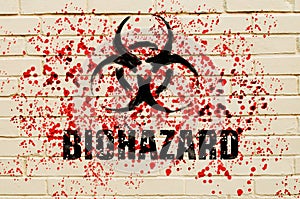 Biohazard sign on the wall with red toxic sprays on the wall.