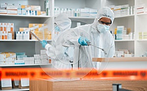 Biohazard, spray and disinfect with people in a pharmacy for decontamination after a medical accident. Hazmat, chemical