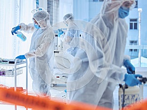 Biohazard team sterilise a hospital room together. Science team cleaning a medical center together. Medical team use
