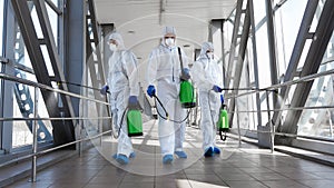 Men in a protective suit and mask disinfecting tunnel with gas photo