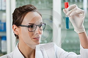 Biologist analyzing test tube with chemical liquid