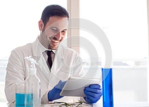 Biologist analyzing tests on tablet in laboratory