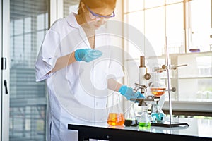 Biologist asian woman working with medical chemicals sample test at laboratary