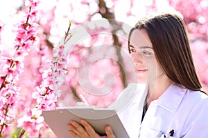 Biologist checking flowers in springtime in a field