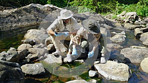 Biologist collecting natural water samples for research