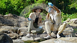 Biologist collecting natural water samples for research,