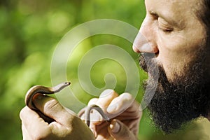 Biologist holding little snake