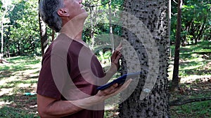 Biologist inspecting the thorns on the the Anigic Tree