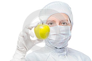 Biologist in a protective suit and a good healthy apple