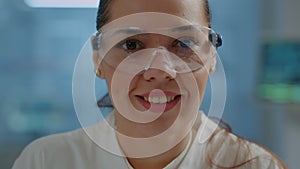 Biologist with safety goggles smiling at camera