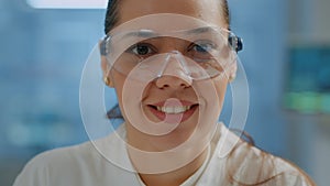 Biologist with safety goggles smiling at camera