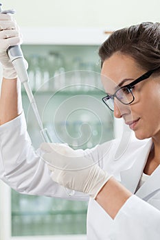 Biologist using pipette