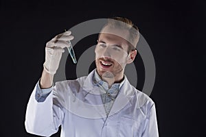 Biologist with a vial smiles