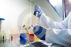 Biologist working in glow box in laboratory