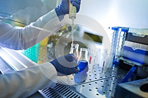 Biologist working in glow box in laboratory