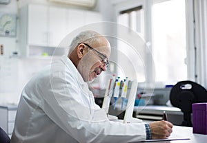 Biologist writing notes in laboratory