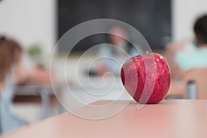 Biology and biochemistry classes. A close-up photo of a bottle containing a green plant and a ripe apple next to the