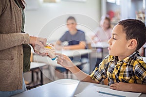 Teenage students with teacher on biology class. Close up