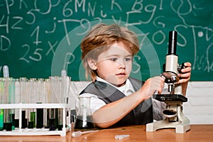 Biology experiments with microscope. September 1. Education. School concept. Preschooler. Little children at school