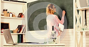 Biology laboratory. Student writing chalkboard defocused. Biology concept. Microbiology and bioengineering. Microscope