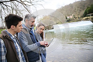 Biology professor with students outdoors