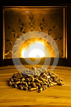 Biomass pellets illuminated by flame from heater