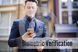 Biometric recognition of a person`s face. A man in a business suit is looking at the phone. Face ID