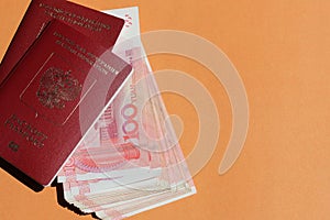 Biometric russian passport and yuan. Tourism, travel and international relations concept. Copy space.