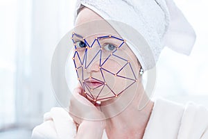 Biometric verification of a modern young woman. New technology of face recognition on polygonal grid photo