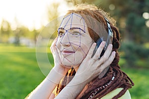 Biometric verification of a modern young woman. New technology of face recognition on polygonal grid photo