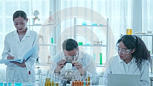 Biotechnology researcher scientist working look microscope in the medical development laboratory for vaccine development.