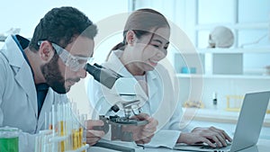 Biotechnology researcher scientist working look microscope in the medical development laboratory for vaccine development.