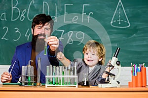 Biotechnoloy research concept. bearded man teacher with little boy. Back to school. Explaining biology to child. father