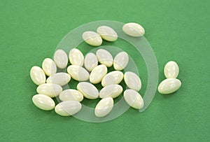 Biotin capsules on green background