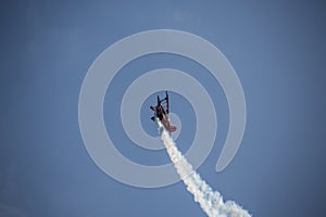 Biplane aerobatic pilot in the sky