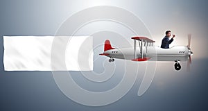 The biplane with businessman and blank banner
