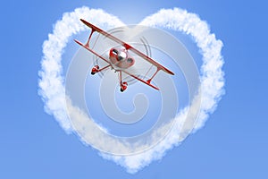 Biplane creating a heart shape in the sky