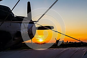 Biplane standing at sunset