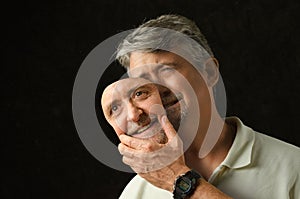 Bipolar disorder depressed man with mask photo