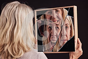Bipolar woman, broken mirror or reflection of anxiety, depression or psychology, identity crisis or schizophrenia