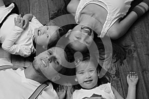 Biracial Asian American family laying on ground