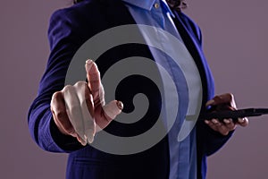 Biracial businesswoman using smartphone with copy space on grey background