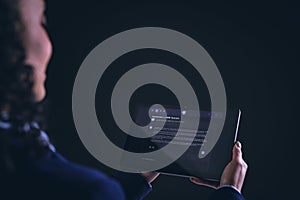 Biracial businesswoman using tablet with copy space on black background