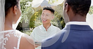 Biracial man officiating wedding ceremony for african american couple in sunny garden, slow motion