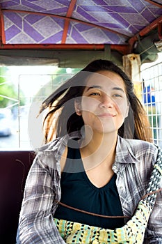 Teen girl riding tuktuk taxi in Cambodia photo