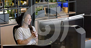 A biracial woman smiles at her business office desk with copy space